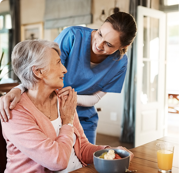 Elderly woman and nurse smiling warmly